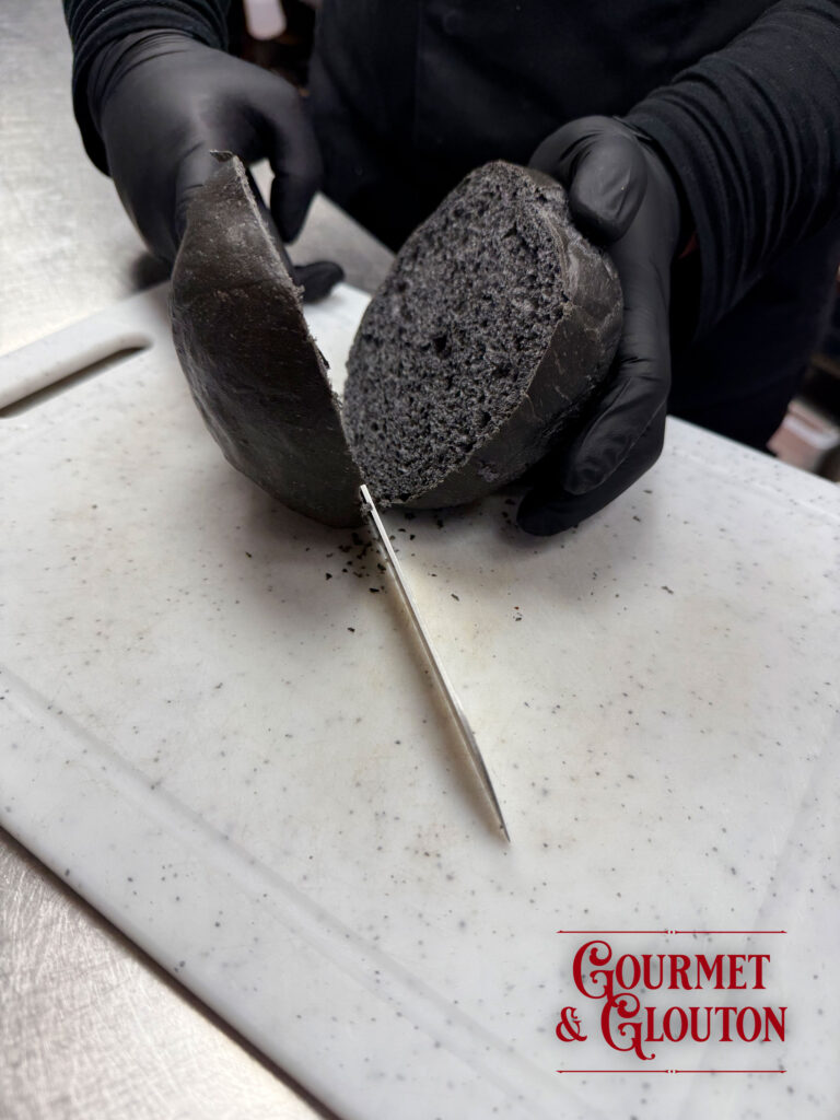 Pain noir au charbon coupé en deux, réalisé en collaboration avec Le Manoir des Saveurs pour Gourmet & Glouton.